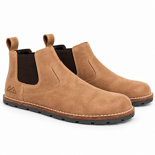 A pair of men's tan suede Chelsea boots with dark brown elastic side panels and black soles, shown on a clean white background.