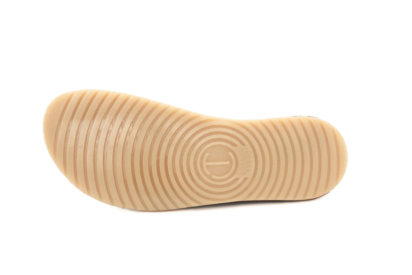 Light brown rubber shoe sole with concentric circular tread pattern and Common Tread logo