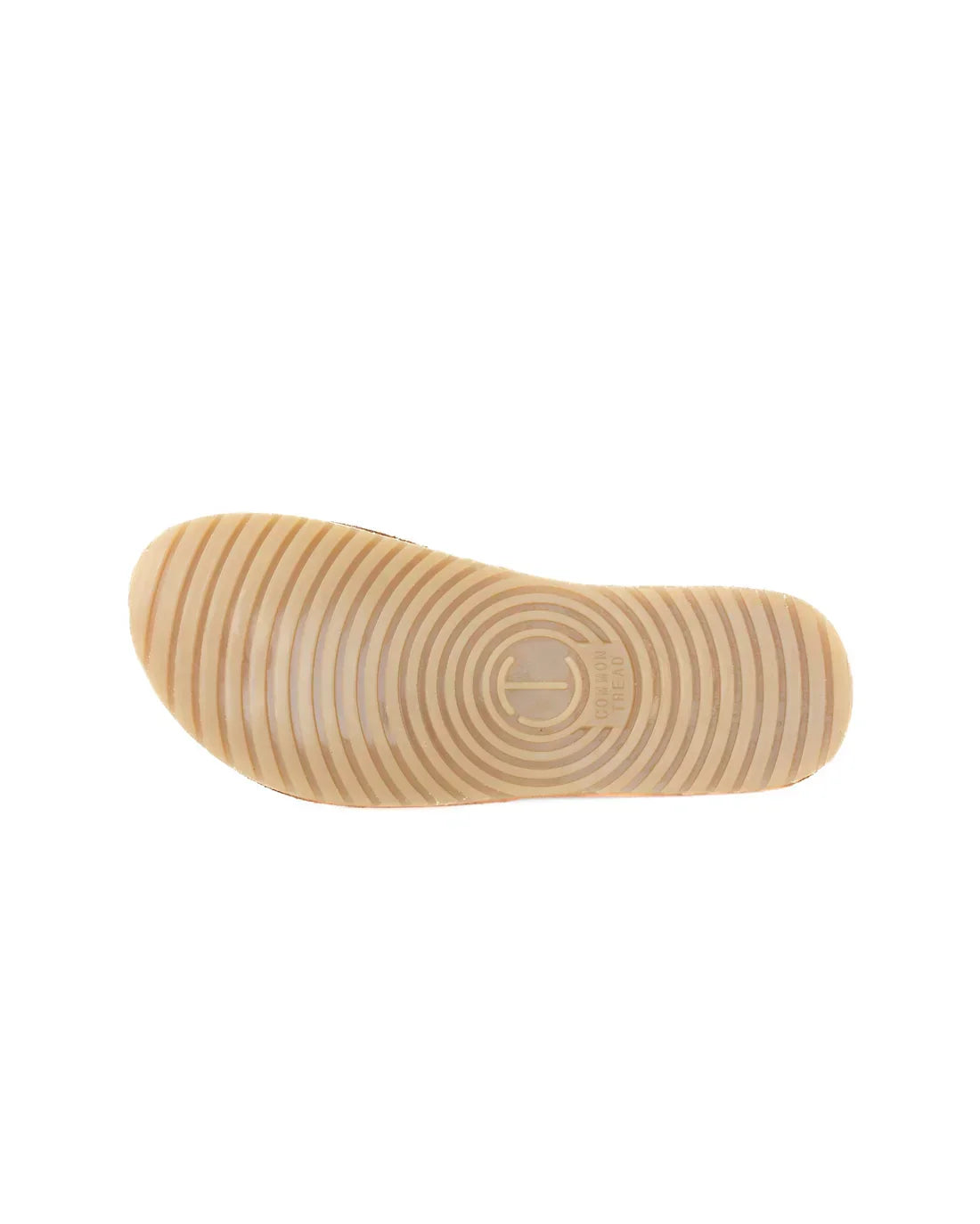 Light brown shoe sole with concentric circle tread pattern and Common Tread logo