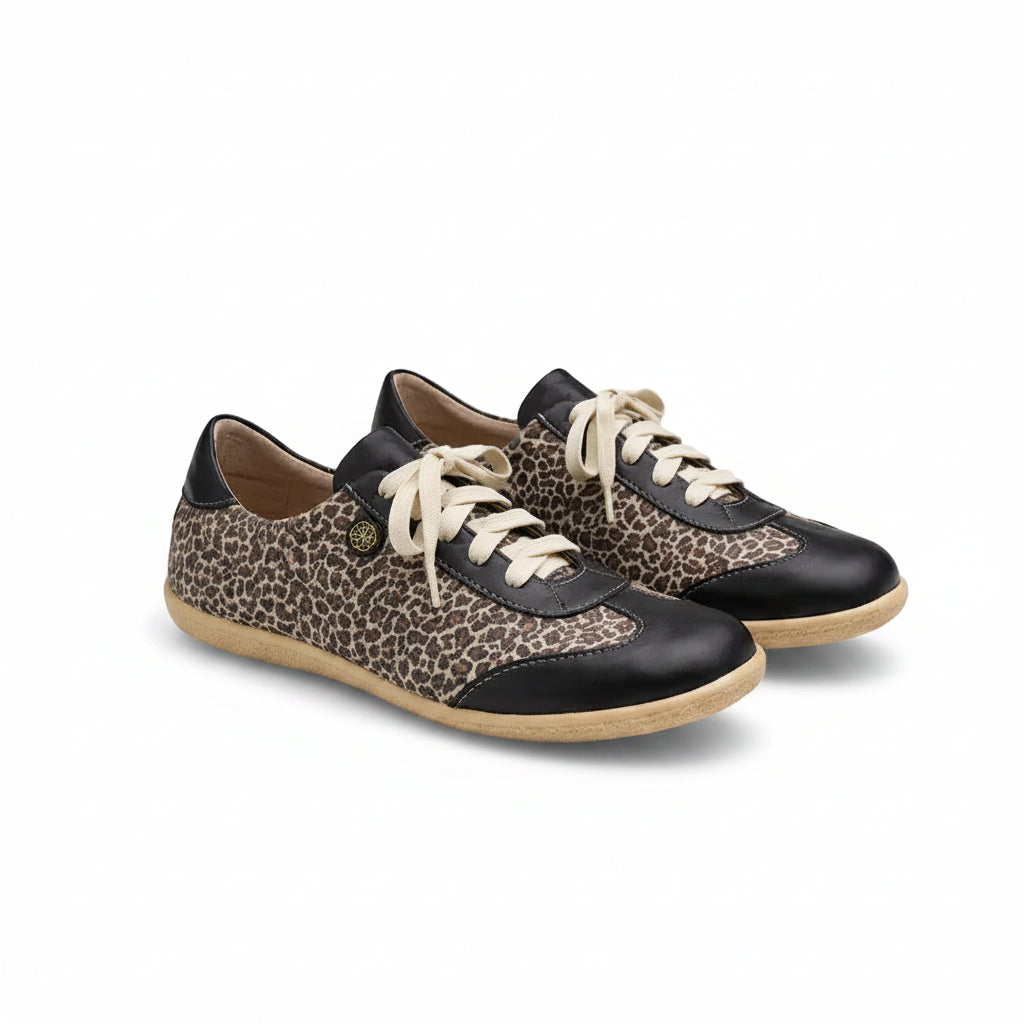 Pair of sneakers with leopard print and black accents on a light gray background