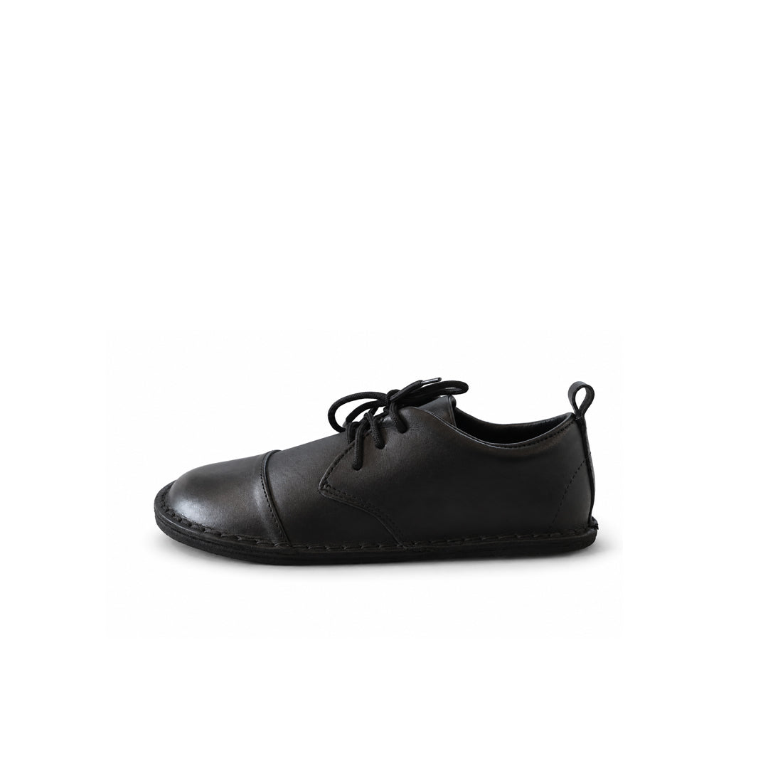 Black high-top sneaker with a brown sole on a white background