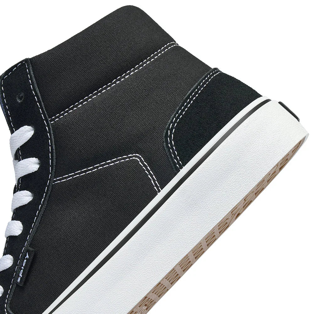 Black high-top canvas sneaker with white stitching, white laces, and thick white rubber sole