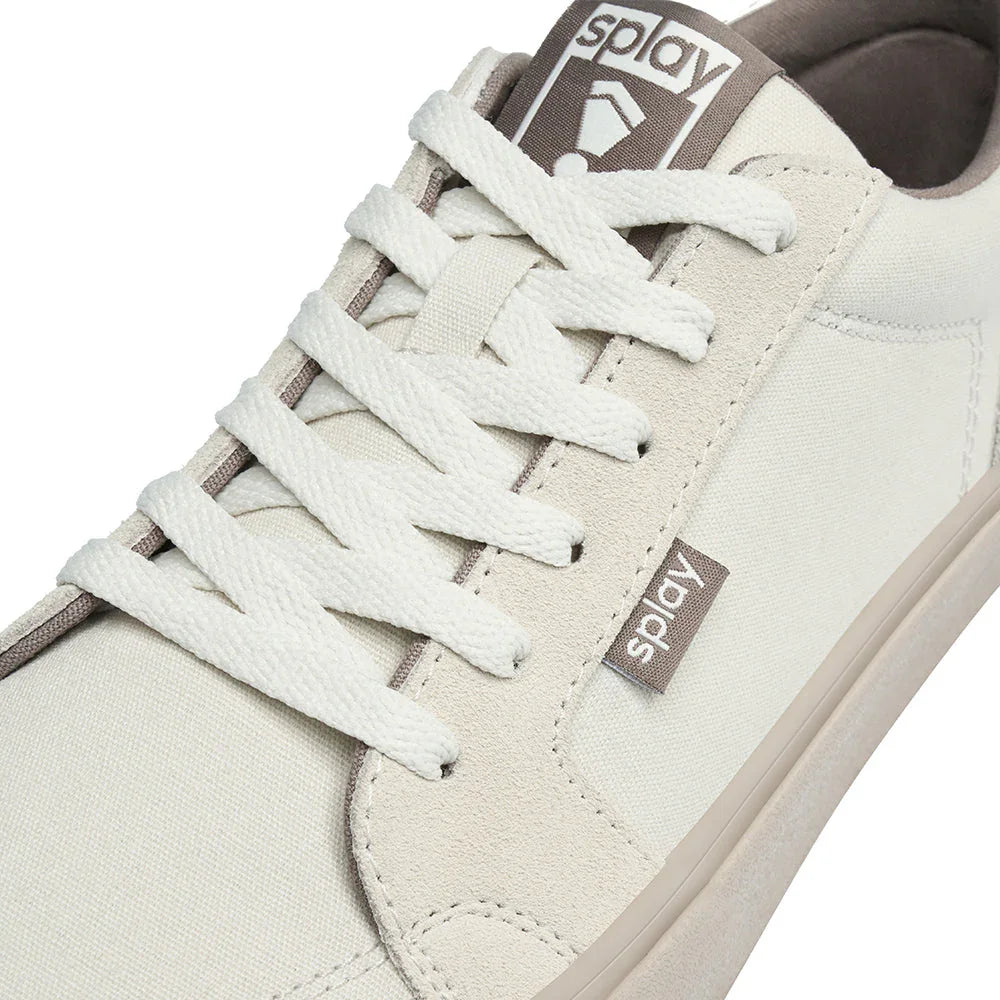 Close-up of beige Splay casual sneaker with white laces and canvas fabric detail