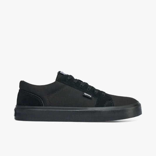 Side view of black low-top canvas sneaker with rubber sole and splay logo tag