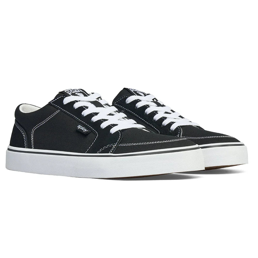 Black canvas low-top sneakers with white laces, white stitching, and thick white rubber sole