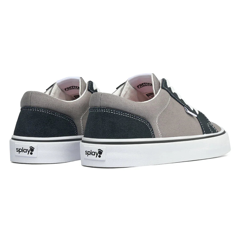 Pair of gray and black canvas sneakers with white soles and splay logo on heel