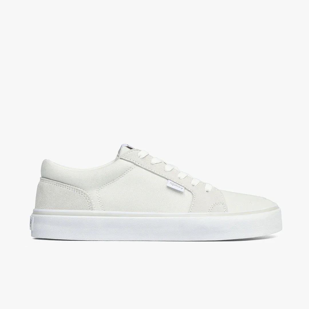 Minimalist white low-top canvas sneaker with white rubber sole and white laces