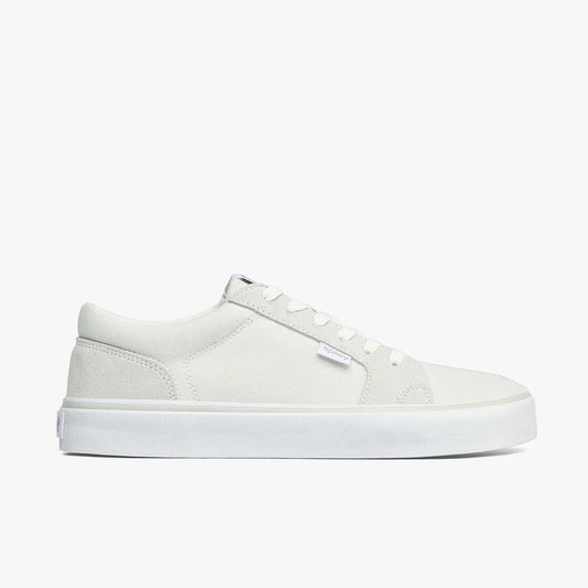 Minimalist white low-top canvas sneaker with white rubber sole and white laces