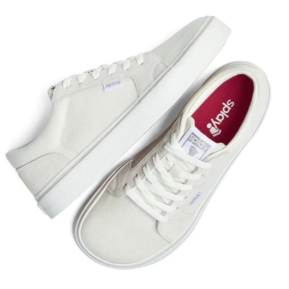 Pair of white canvas casual sneakers with white laces and red insoles, side and top views