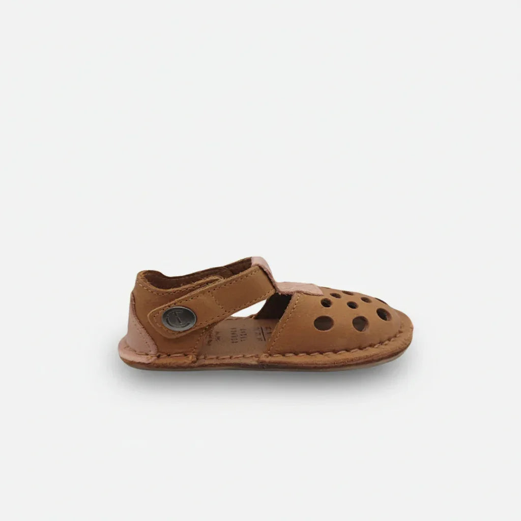 Brown leather toddler sandal with perforated upper and Velcro strap on white background