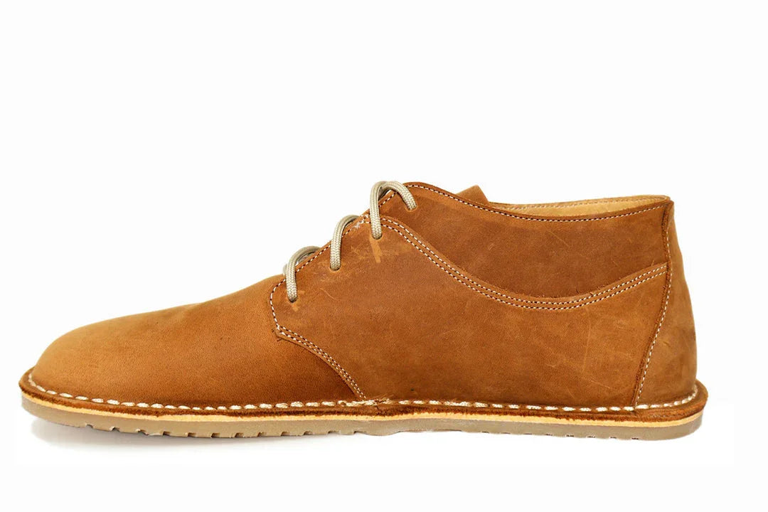 Side view of a brown leather casual men's shoe with beige laces and a stitched sole