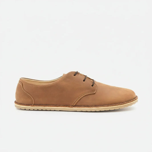 Side view of tan brown leather casual men's shoe with beige sole and dark laces