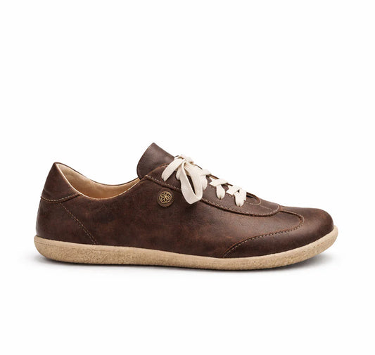Brown leather sneaker with white laces on a white background