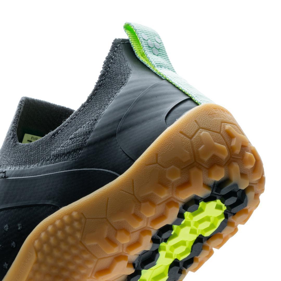 Close-up of Vivobarefoot Primus Trail Knit FG men's graphite and gum barefoot shoe, hex tread sole